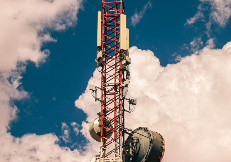Telecommunications mast against cloud