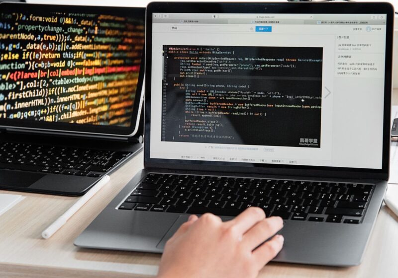 Developer writing code on a laptop
